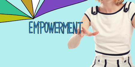 Empowerment concept with young woman on a blue backgroundの写真素材