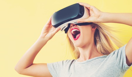 Happy young woman using a virtual reality headset