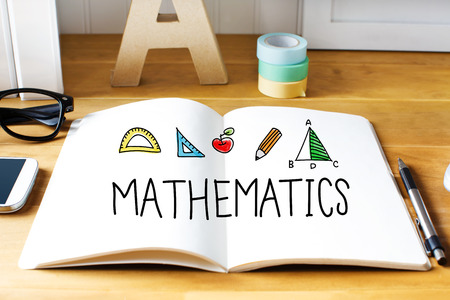 Mathematics concept with notebook on wooden deskの写真素材