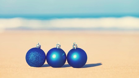 Christmas ornaments in the sand on a tropical beachの写真素材
