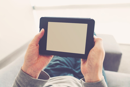 Man reading an e-book on digital tablet deviceの写真素材