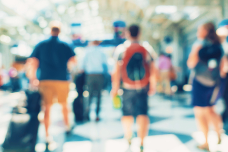 Defocused airport corridor with walking travelersの写真素材