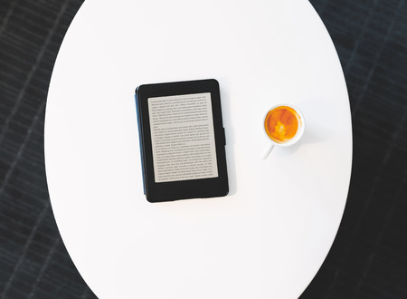 Top down view of digital e-book device with coffeeの写真素材