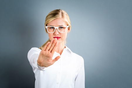 Young woman making a rejection pose on a gray backgroundの写真素材