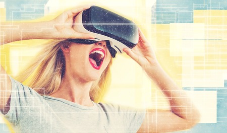 Happy young woman using a virtual reality headset concept