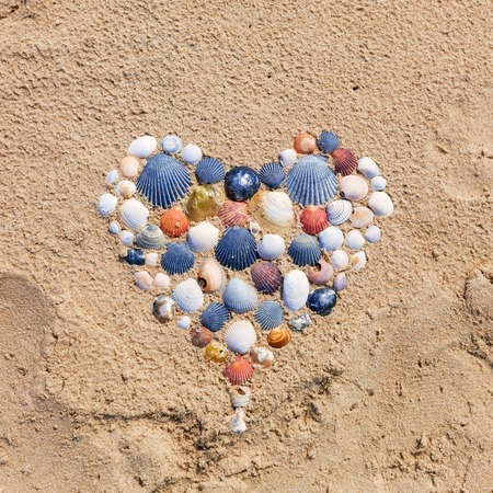 Heart shape made of seashells on the beach