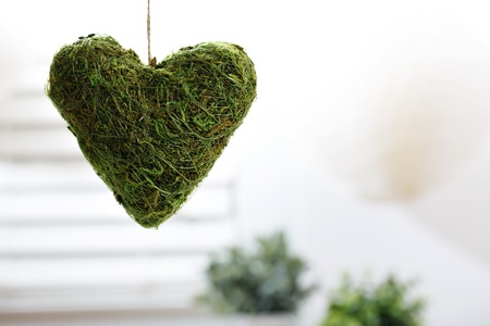 Hanging decorative heart in a bright interior roomの写真素材