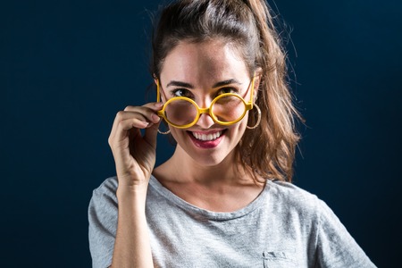 Happy young woman on a dark blue backgroundの写真素材