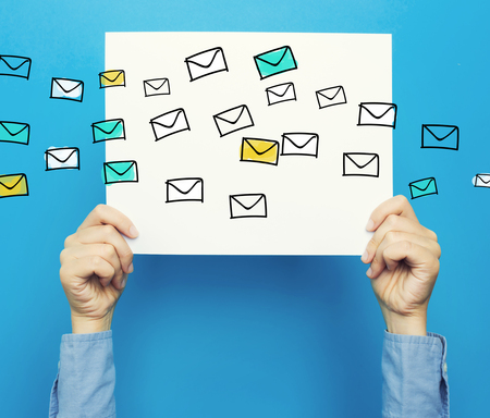 Emails on white poster on a blue backgroundの写真素材