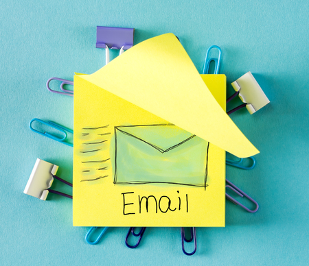 Email on a sticky note on a blue backgroundの写真素材