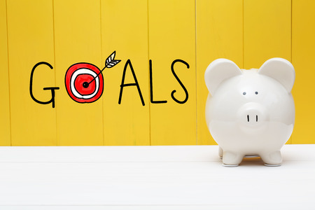 Goals text with piggy bank over yellow wallの写真素材