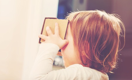 Toddler girl using a new virtual reality headsetの写真素材