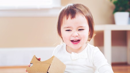 Toddler girl using a new virtual reality headsetの写真素材