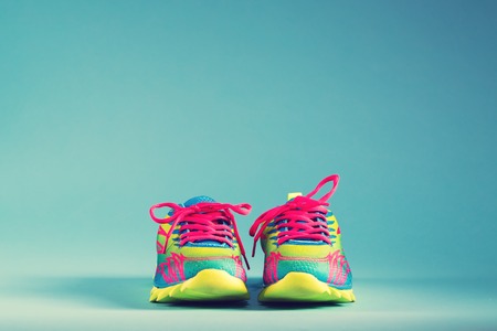 Pair of colorful running sneakers on a blue background