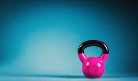 Pink kettlebell on a blue gradient backgroundの写真素材
