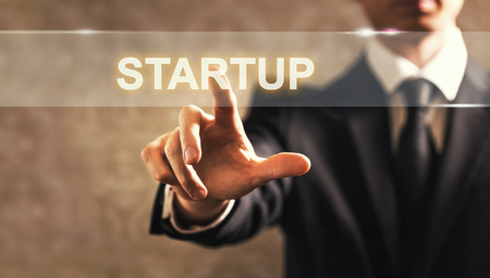 Startup text with businessman on dark vintage backgroundの写真素材