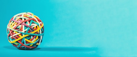 Elastic rubber band ball on a blue backgroundの写真素材