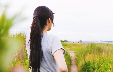 Woman looking out at the path that lies aheadの写真素材