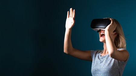 Happy young woman using a virtual reality headset