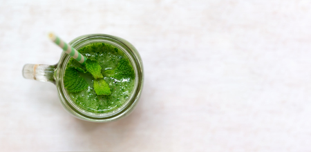 Kale and greens smoothie beverage in a bright roomの写真素材