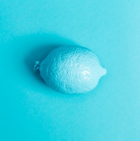 Painted fruit on a bright blue backgroundの写真素材