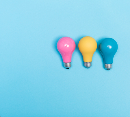 Colored light bulbs on vivid colored background