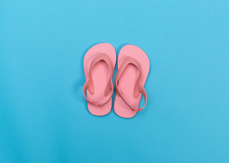Beach sandals on a vibrant blue backgroundの写真素材