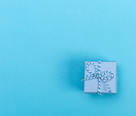Little handmade present box on a blue background