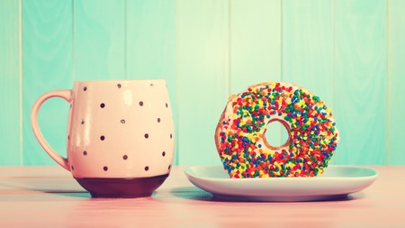 Donut and dish with pink vintage style coffee mugの写真素材