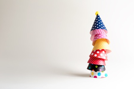 Party theme with with hats on an off white background