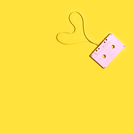 Pink cassette tape on a yellow backgroundの写真素材