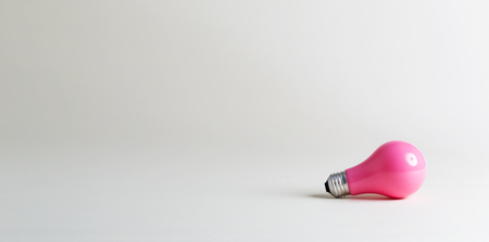 Colored lightbulb on an off white backgroundの写真素材