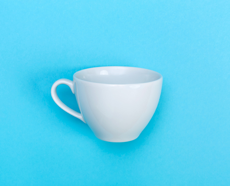 White coffee mug on a bright blue backgroundの写真素材