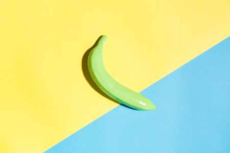 Painted banana on a vibrant split tone backgroundの写真素材