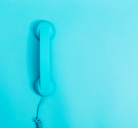 Old style retro telephone on a blue background