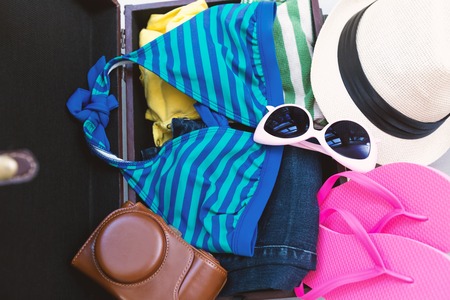 Packing a suitcase and backpack for a tripの写真素材