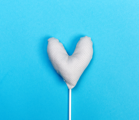 Handmade heart cushions on a blue backgroundの写真素材