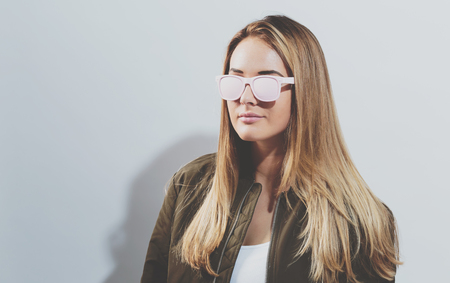 Hipster girl wearing sunglasses on a white backgroundの写真素材