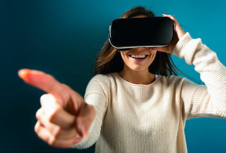 Happy young woman using a virtual reality headset