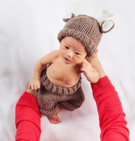 Newborn baby boy being cared for by his motherの写真素材