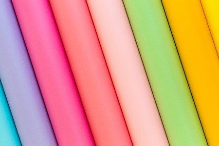 Colorful bright rolls of a paper arranged in a row