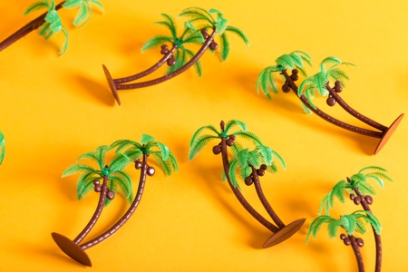 Tropical theme with little palm trees on a yellow backgroundの写真素材