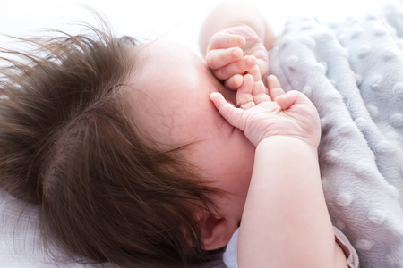 Little baby boy sleeping in his houseの写真素材