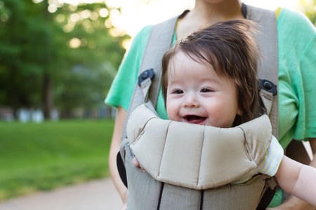 Happy baby boy outside with his familyの写真素材