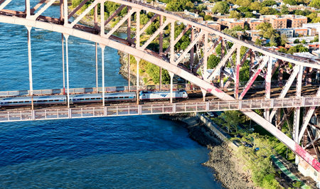 NEW YORK - JULY 02 2016: Aerial view of and Amtrak train crossing the Hell Gate Bridge in New York Cityのeditorial素材