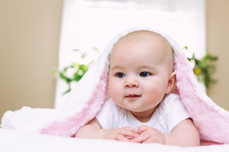 Newborn baby girl on her blanket at homeの写真素材