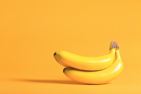 Bunch of bananas on a bright yellow background