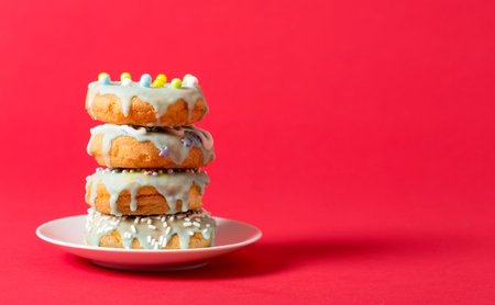 Colorful glazed donuts on a bright backgroundの写真素材