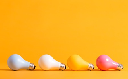 Colored light bulbs in arranged on a yellow backgroundの写真素材
