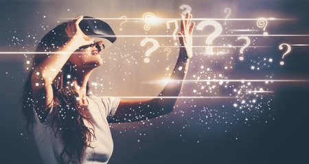 Question Marks with young woman using a virtual reality headsetの写真素材